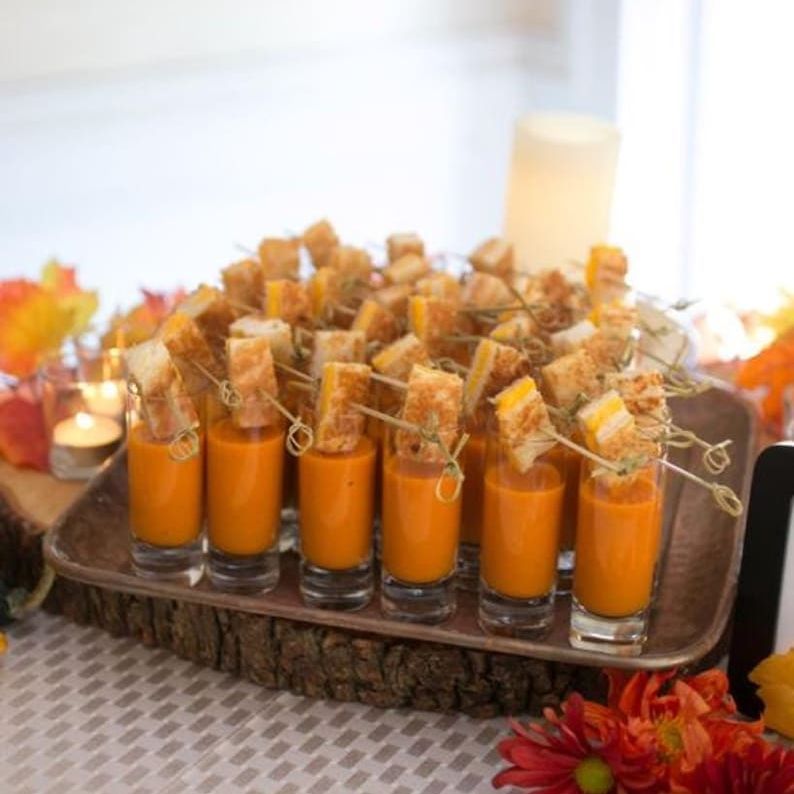 Mini acrylic soup cups filled with soup and topped with croutons, showcasing an elegant design ideal for upscale events and functional single-serve portions.