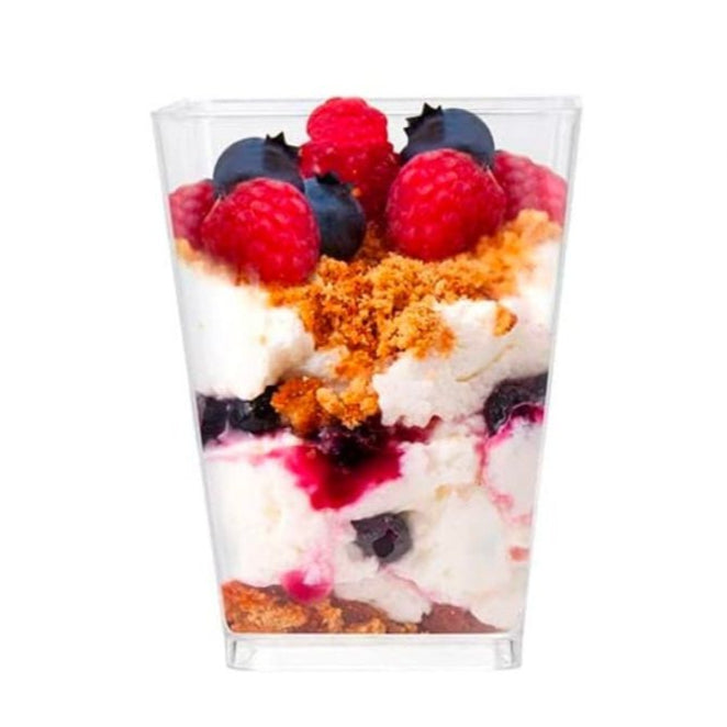 Stack of empty acrylic parfait cups with lids for wedding dessert favors