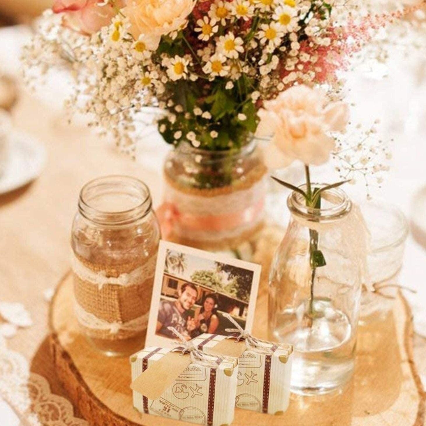Table display with mini suitcase party favor boxes for travel themed party