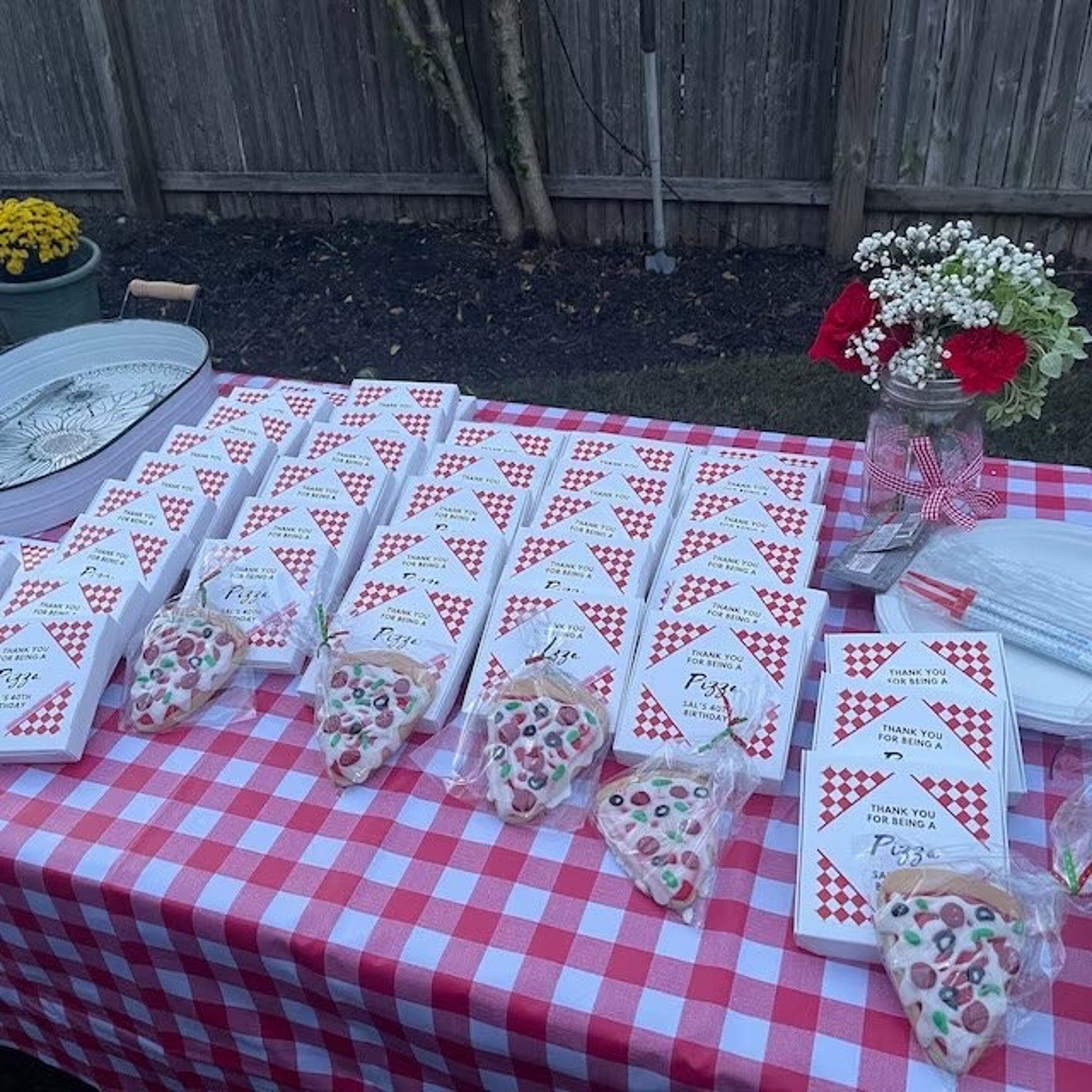 Tiny pizza boxes arranged on a pizza-themed baby shower dessert table.