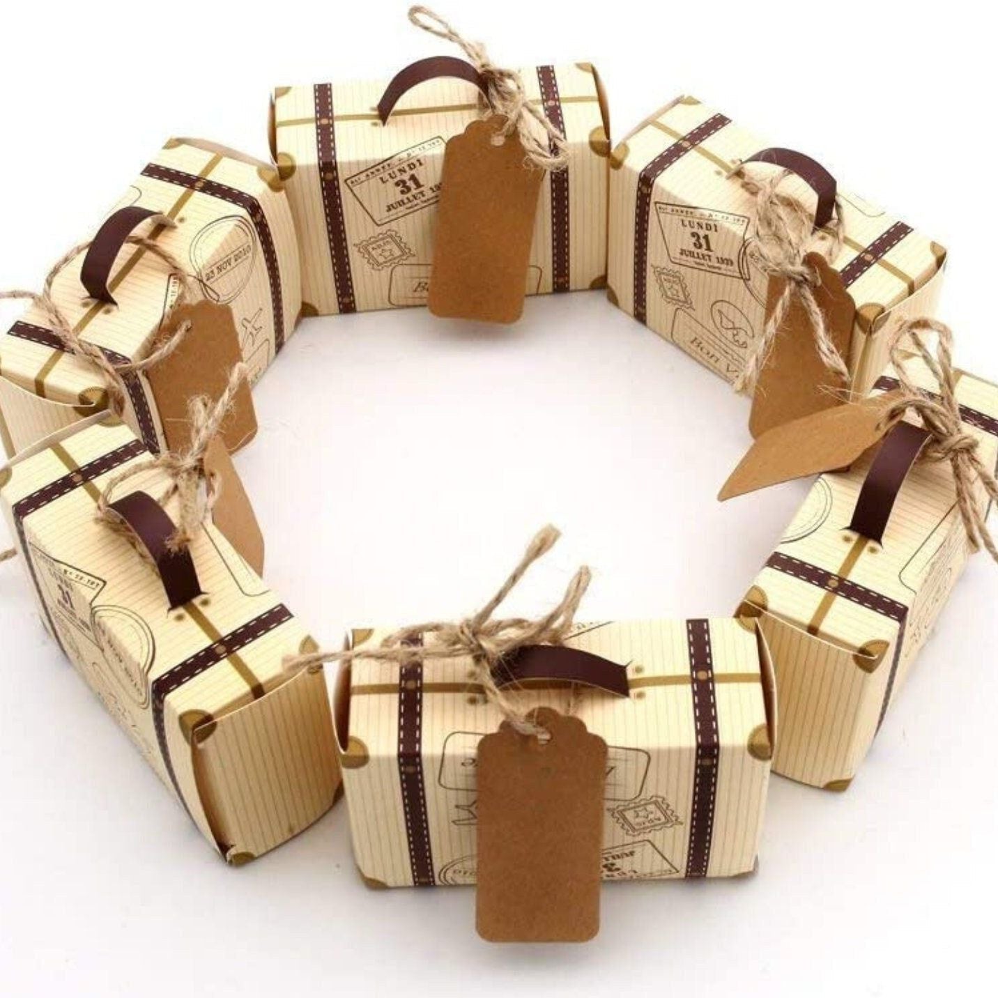 Travel themed party favors with mini suitcase boxes, tags, and twine