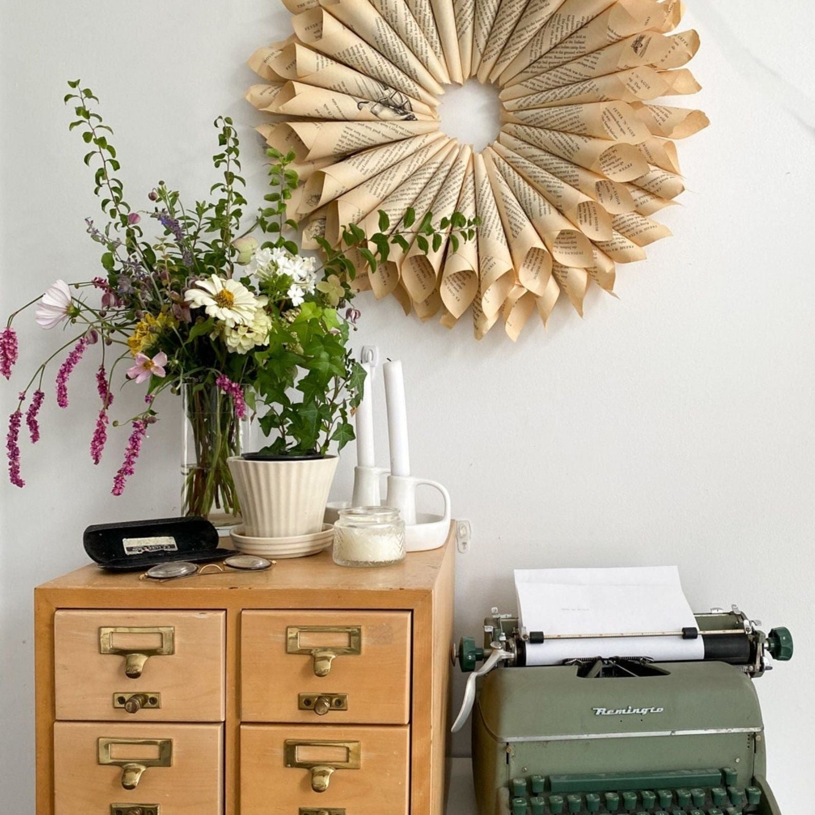 Wedding table decorated with vintage book pages for a rustic look.