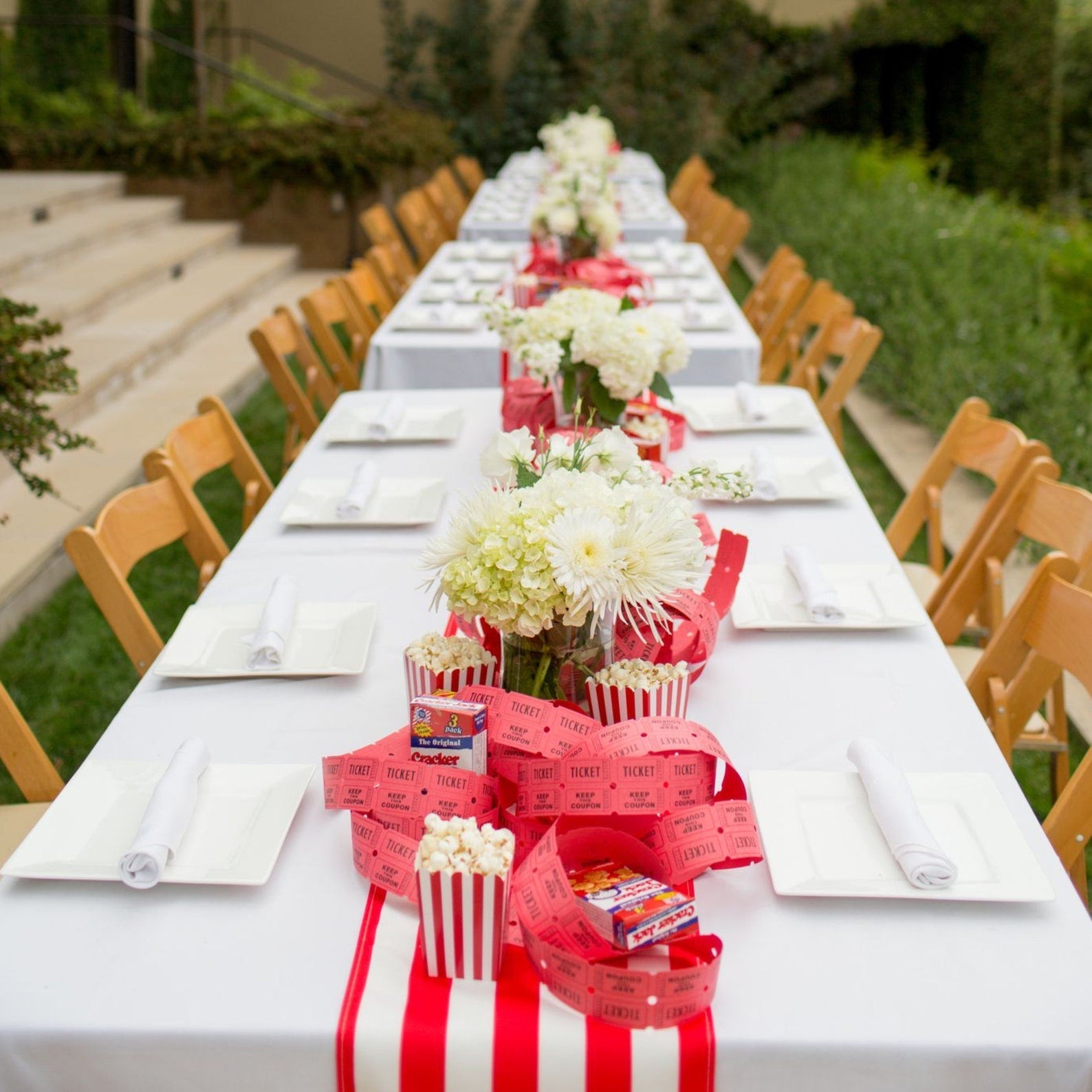 White-striped mini popcorn boxes neatly assembled on a bridal shower dessert table.