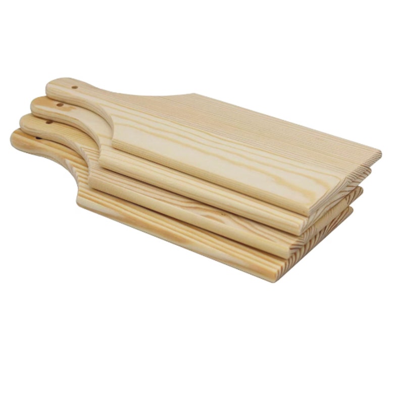 Stack of plain pine wood charcuterie boards with handled shape