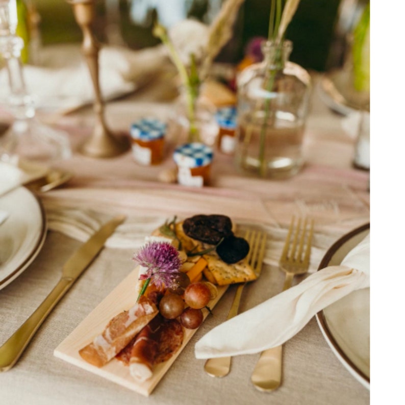 Elegant place setting with mini wooden cheese board and gold flatware