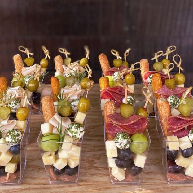 Cheese cubes and olives in clear acrylic appetizer cup with toothpick