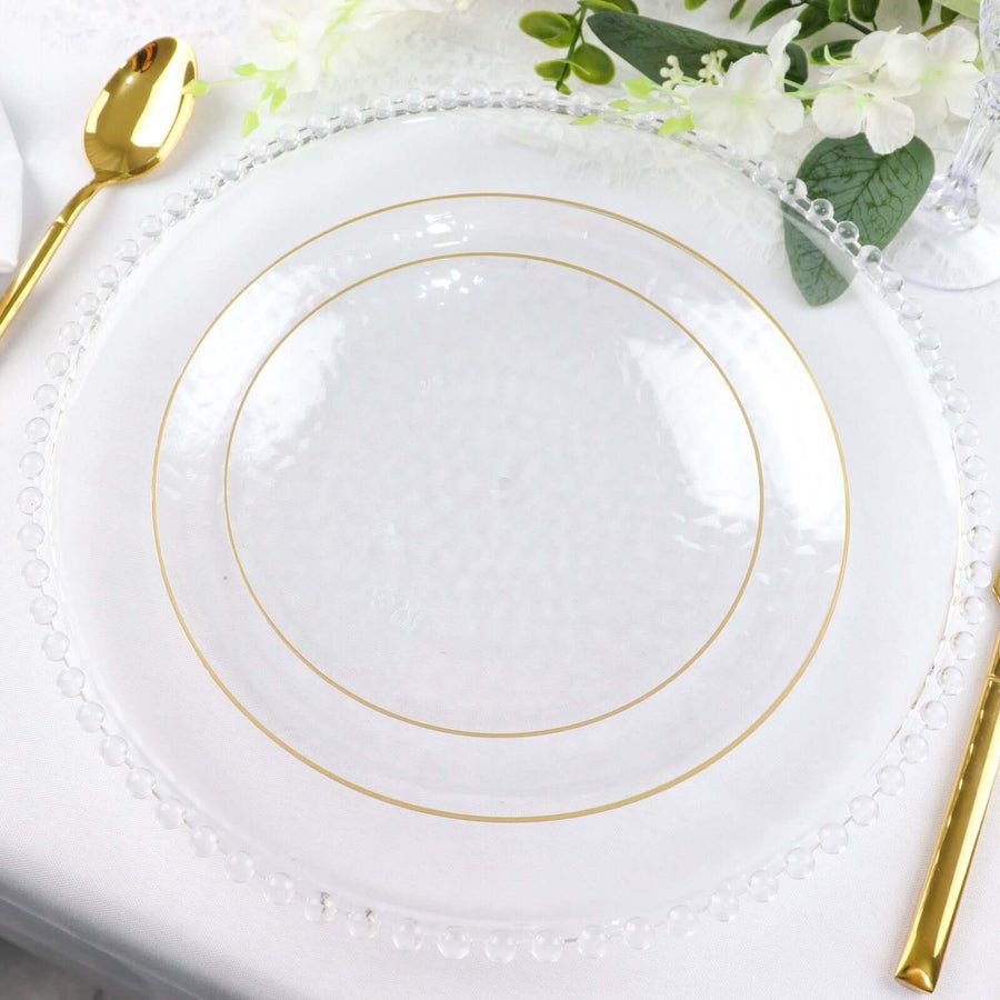 Clear hammered plastic charger plate with gold rim. Elegant disposable dinnerware for weddings & parties.
