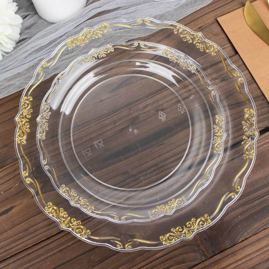 Clear baroque charger plate with gold rim set with smaller clear plastic dinner plate.