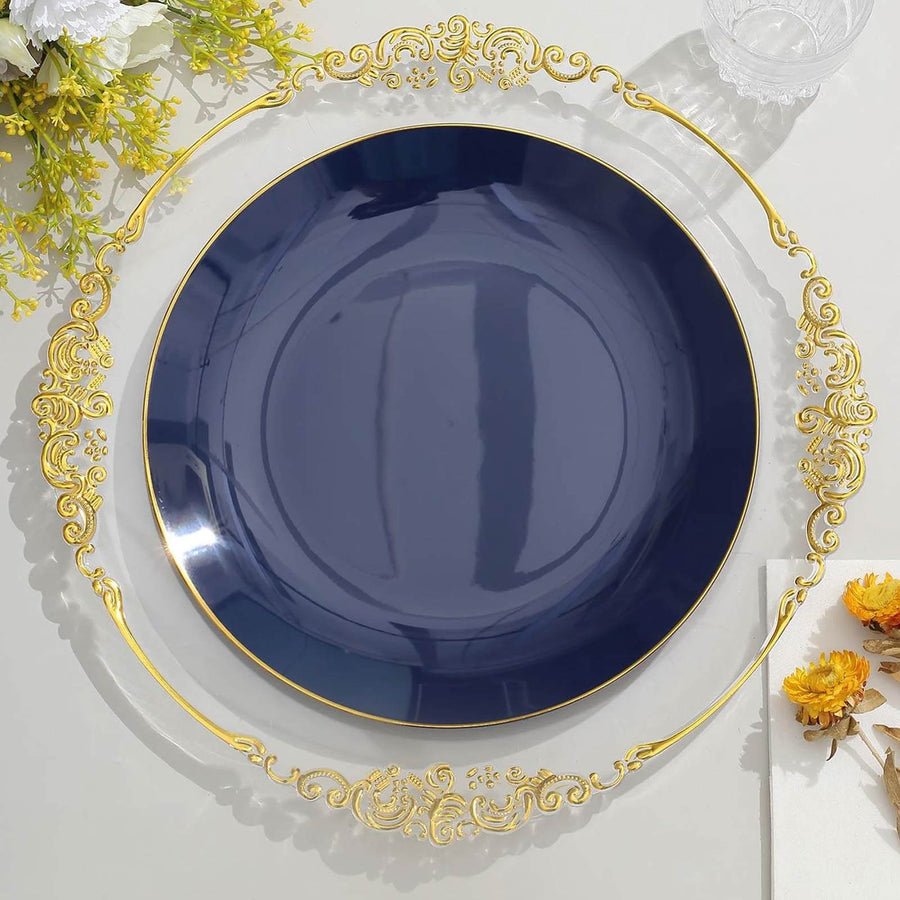 Clear baroque charger plate with ornate gold rim, set with emerald green plates. Luxury wedding decor.