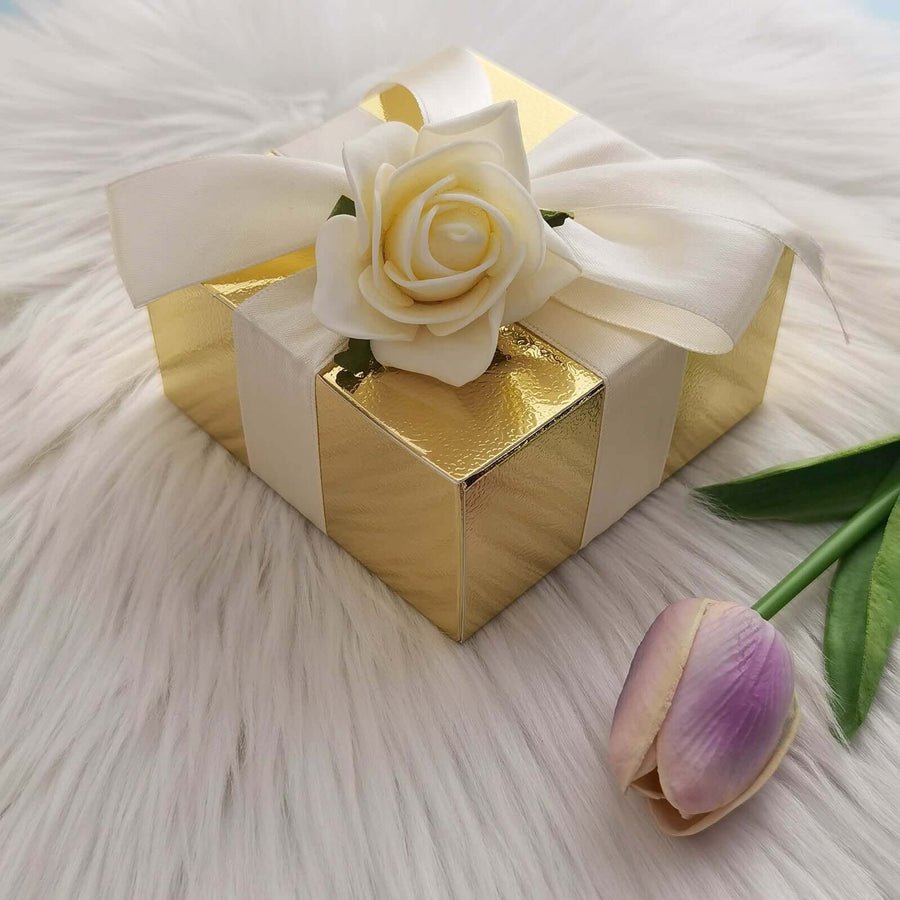 Ivory favor box tied with a satin ribbon. Small, elegant gift box for wedding or party favors.