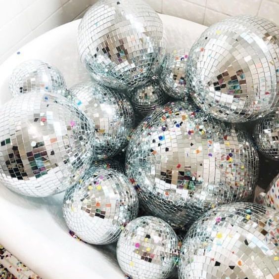 Shimmering 8-inch silver disco ball with mirror tiles, perfect for stunning disco theme party decorations.