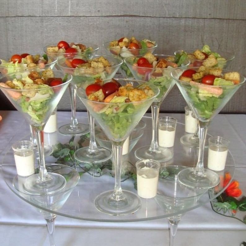 Elegant appetizer display using acrylic cups filled with fresh salad