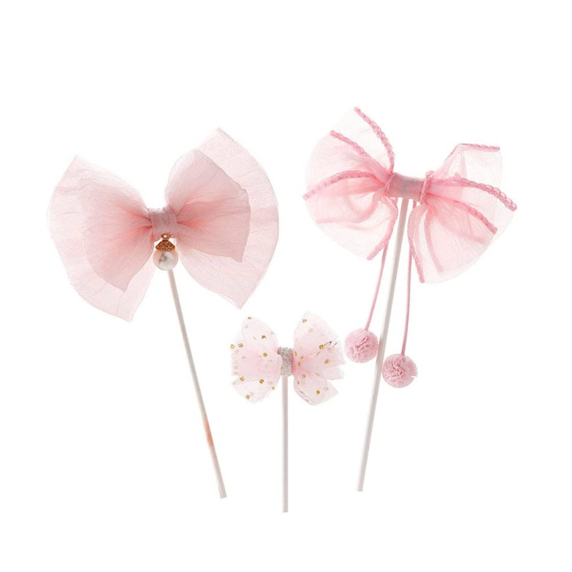 Assorted pink bow cake toppers grouped together in different sizes