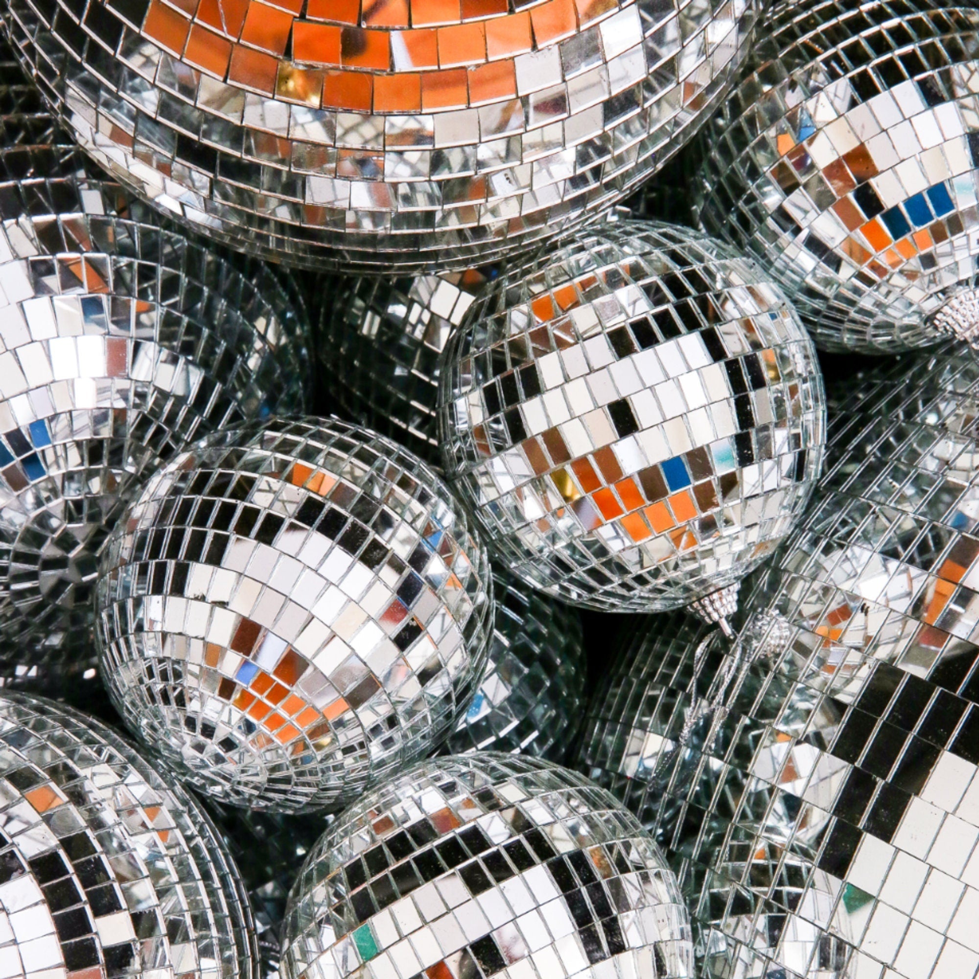 Silver mirror disco balls stacked together for party decorations