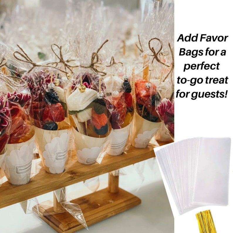 Charcuterie cones wrapped in clear favor bags with gold twist ties