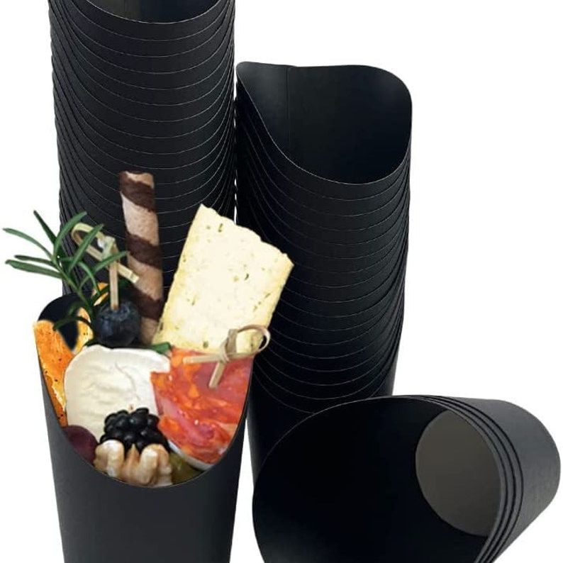Stack of black disposable charcuterie cups ready for serving appetizers.