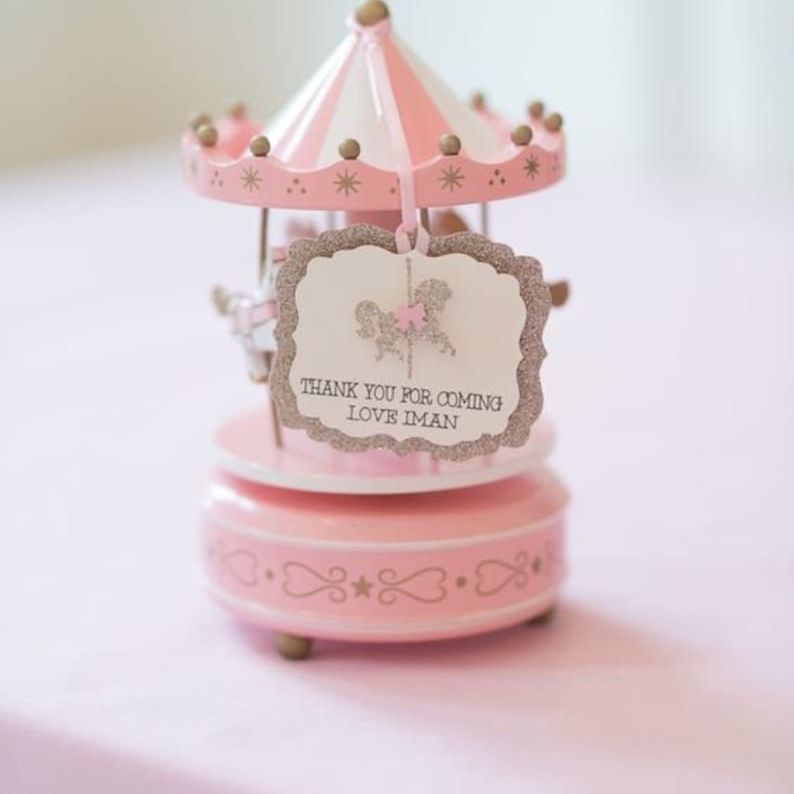Blue carousel horse cake topper with spinning motion and music