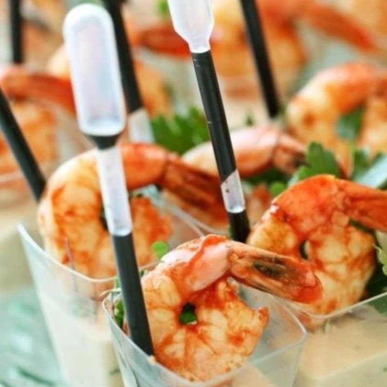 Clear acrylic charcuterie cup with shrimp appetizer, mini fork, and pipette.
