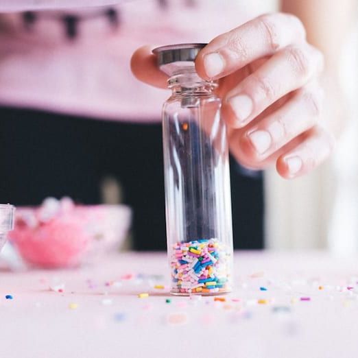 Close-up of 3-inch clear glass cork bottles for sprinkle favors.