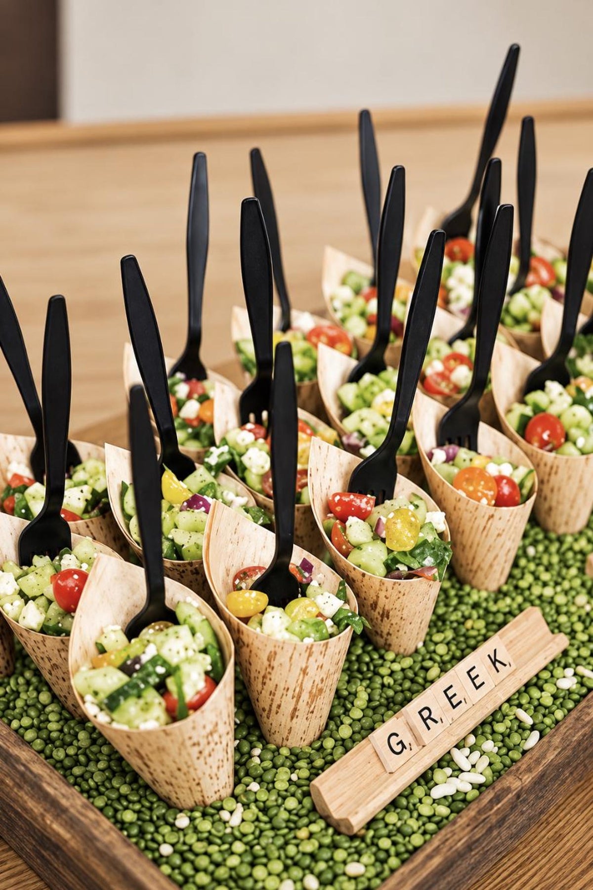 Close-up of charcuterie cup with meat, cheese, and crackers. Individual disposable wooden cone for catering.
