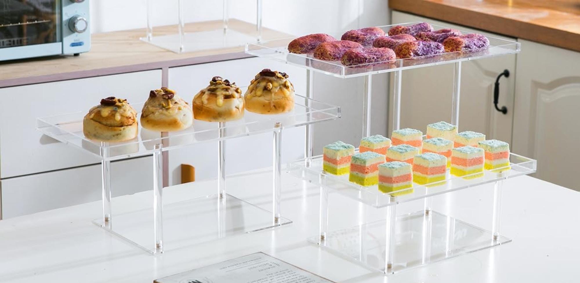 Crystal-clear acrylic cake stands arranged for wedding dessert table setup