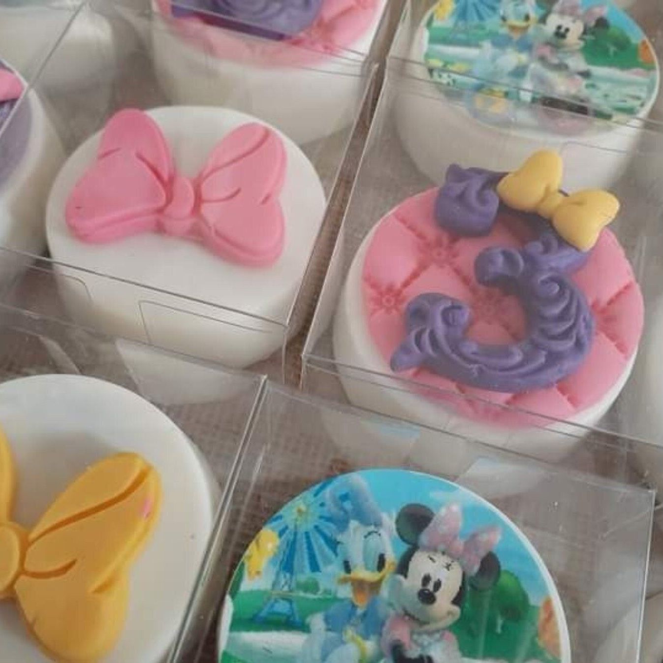 Assorted decorated cookies packaged individually in transparent PET cubes