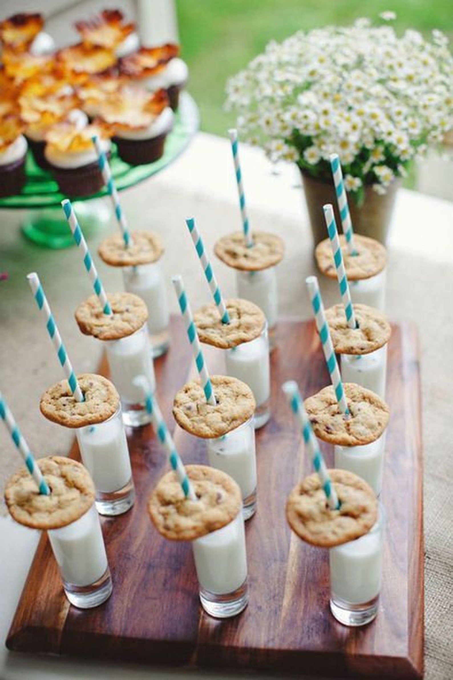 Tray of 3 oz clear acrylic dessert cups with milk and cookies and pink striped straws