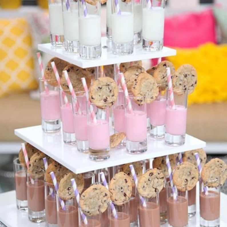 Tiered dessert display with small acrylic dessert cups for milk, strawberry, and chocolate shooters
