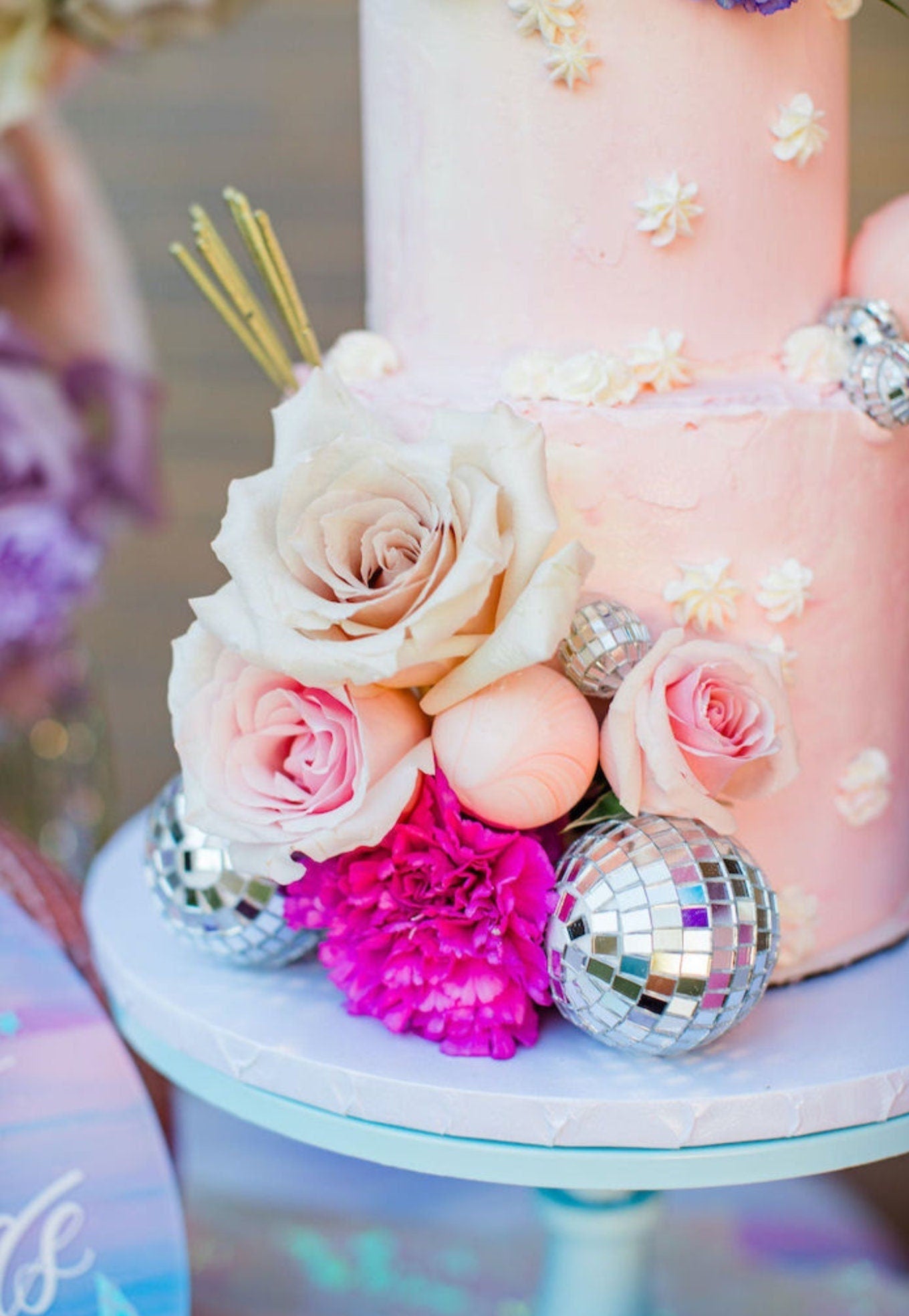 Mini silver disco ball as cake decoration with flowers