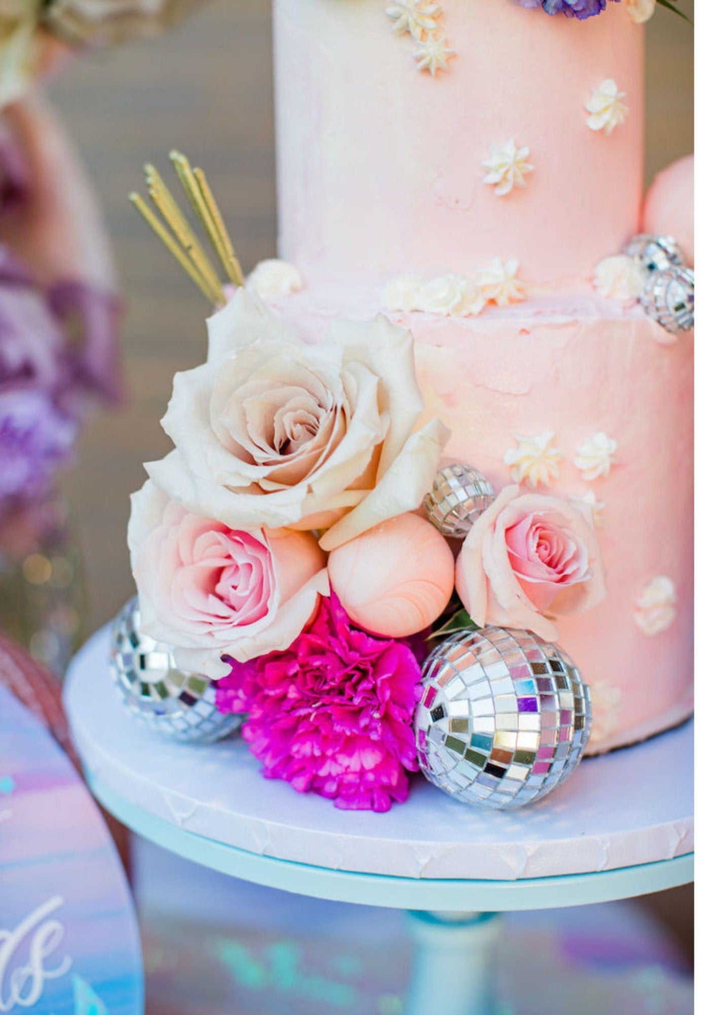 Mini silver disco ball as cake decoration with flowers