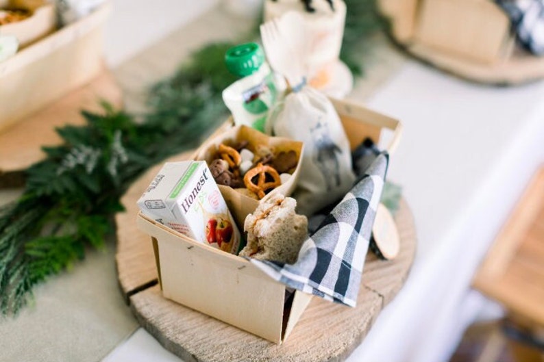 Disposable wooden charcuterie cups with various cheeses, meats, and crackers. Eco-friendly appetizer cones.