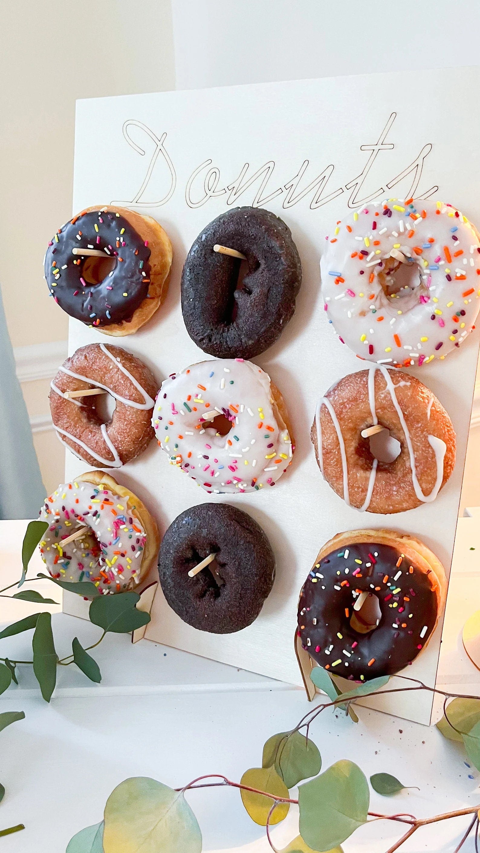 Donut wall and stacking stand together as part of a tabletop dessert vignette