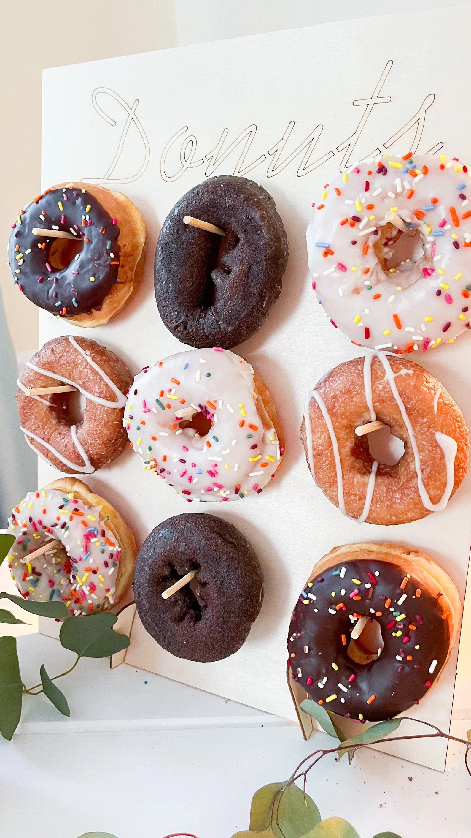 Side view of donut wall display showing rows of donuts hanging on pegs