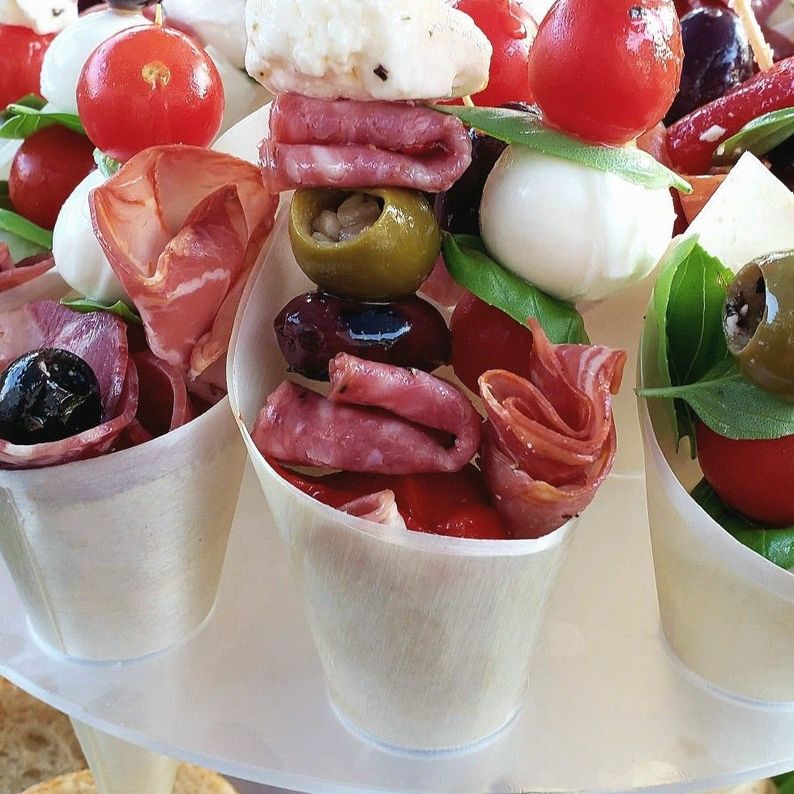Grazing table display featuring bamboo cones filled with charcuterie and appetizers