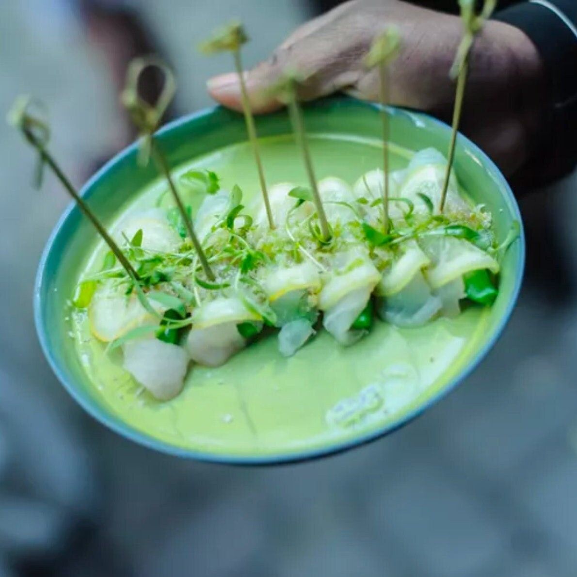Green soup bites skewered with knotted bamboo charcuterie toothpicks