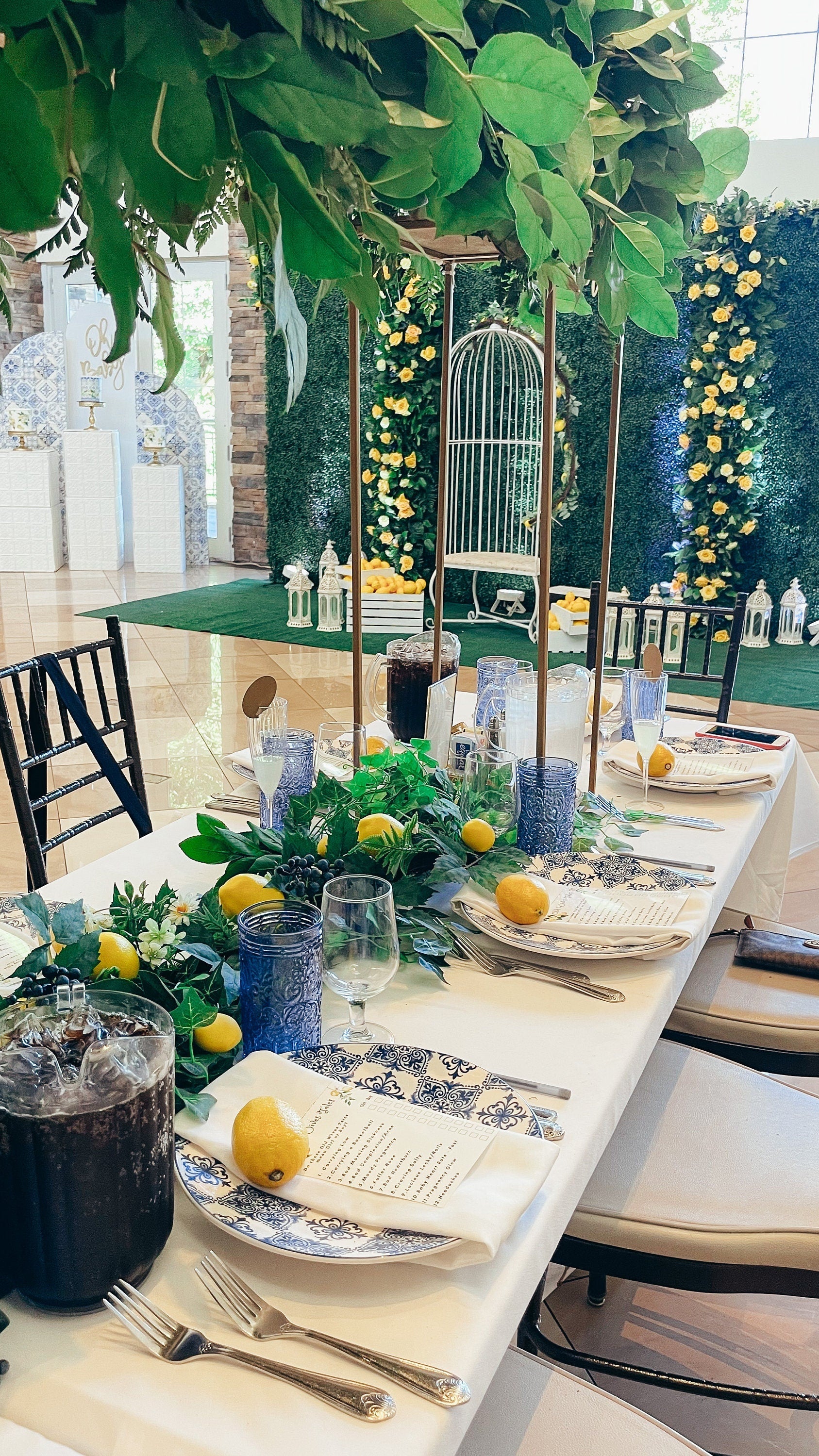 Close-up of lemon Italian themed bridal shower table setup with greenery