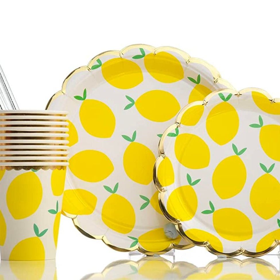 Close-up of lemon paper plates and cups stacked together for party display