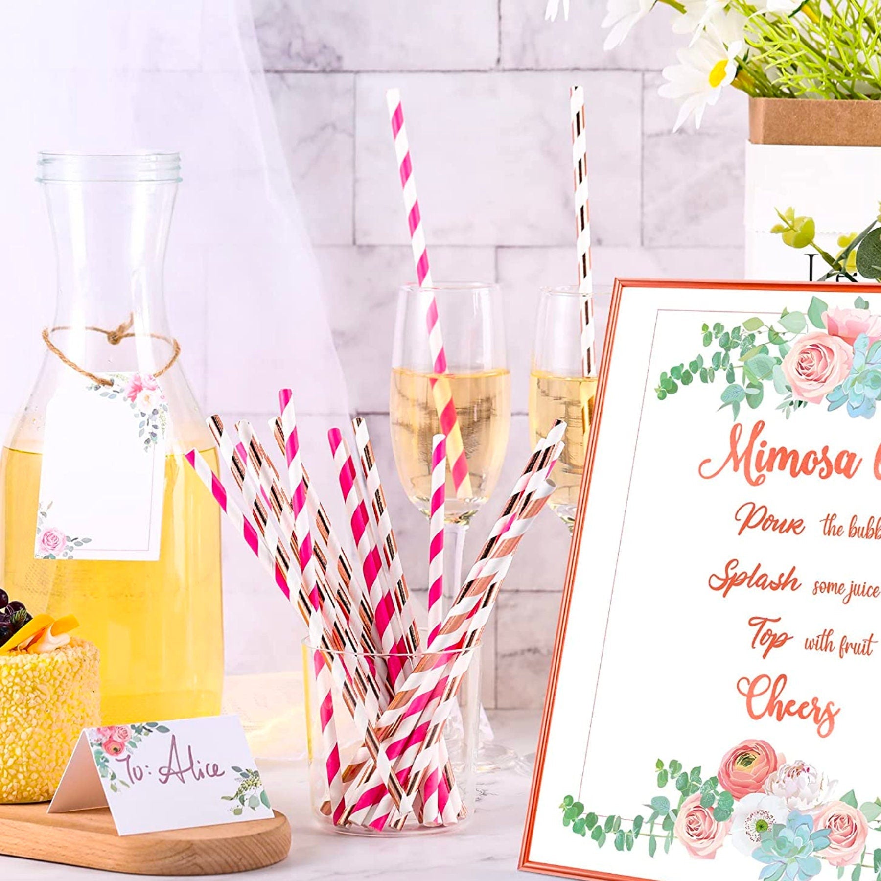 Living room party display with mimosa bar sign, banner, juices, and balloons