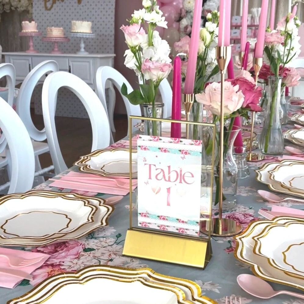Place settings at an elegant event using pink and gold party tableware