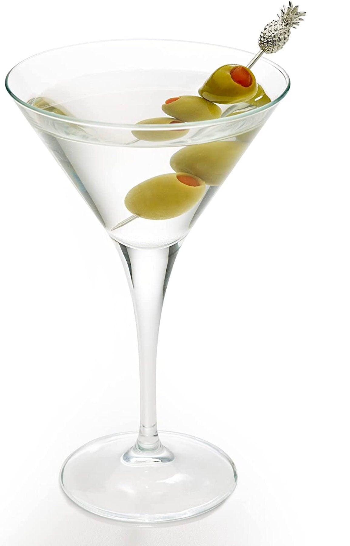 Martini glass with olives stirred by pineapple cocktail stick