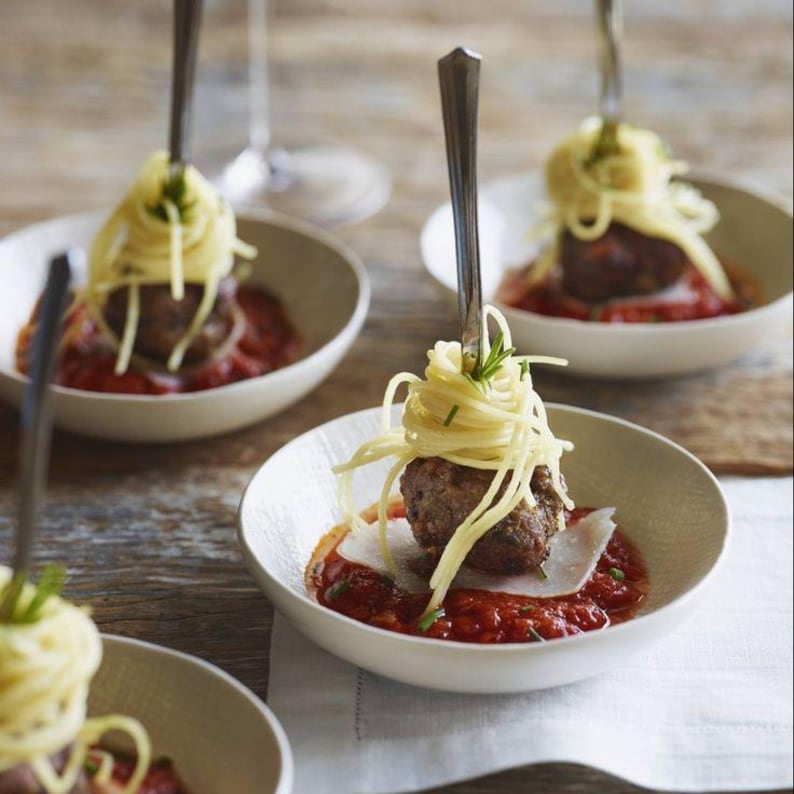 Meatball with pasta elegantly served in a white modern mini plastic bowl, showcasing its stylish use as appetizer bowls for events or catering.