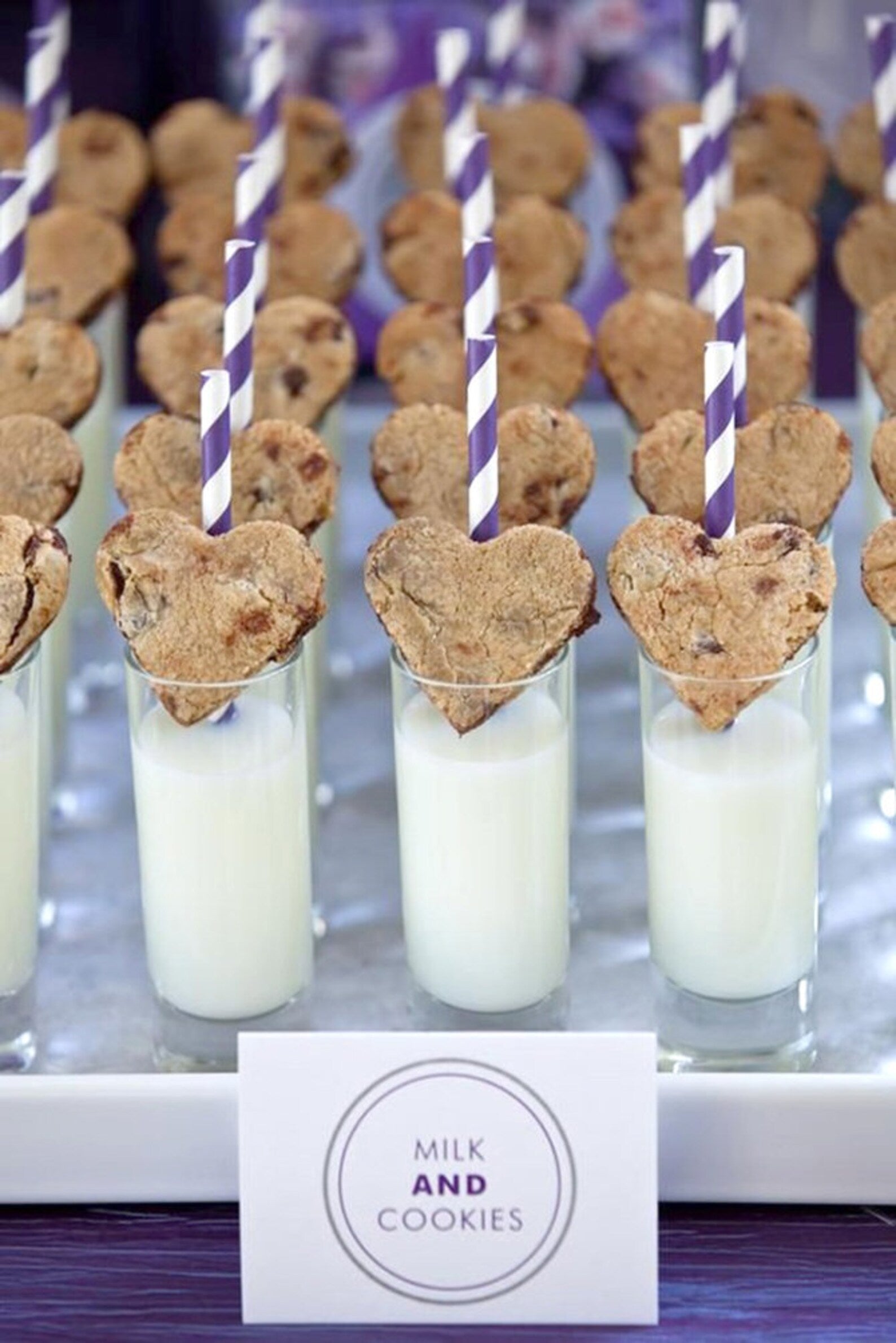 Tray of 3 oz clear acrylic dessert cups with milk and cookies and pink striped straws