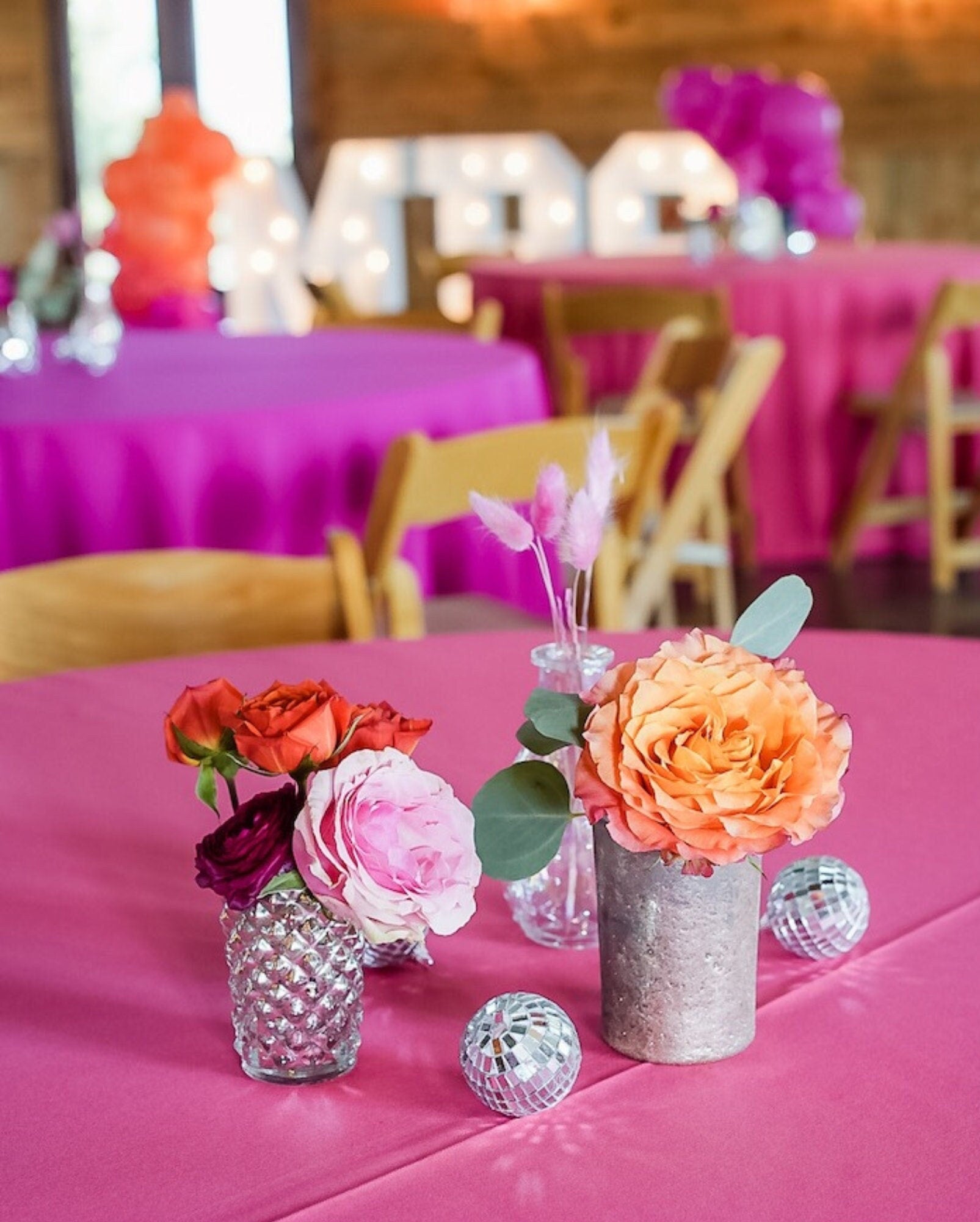 Mini silver disco balls used as table centerpieces for weddings or parties