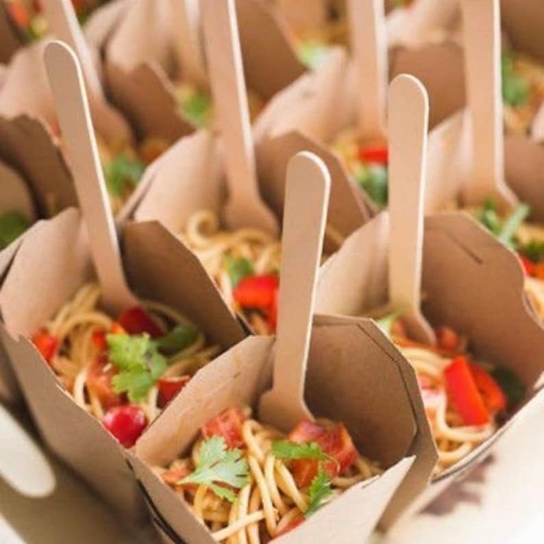 Mini Chinese boxes holding noodles on a grazing table display.