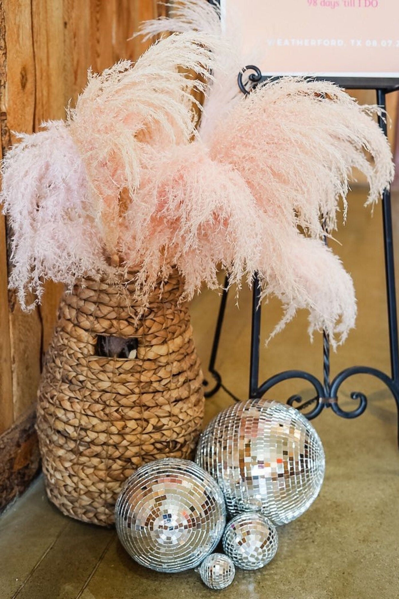 Silver disco balls styled with pampas grass in woven basket décor
