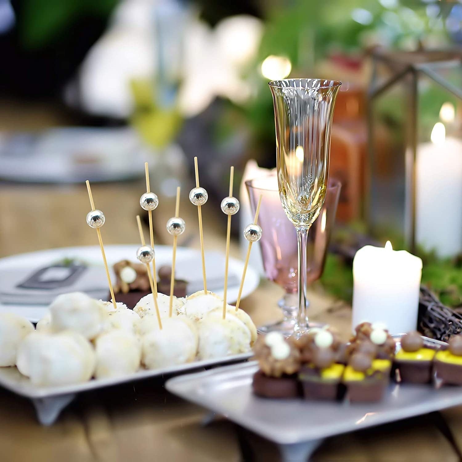 Party appetizers skewered with assorted color fancy toothpicks in red, blue, pink, gold, silver and pearl beads for elegant presentation.