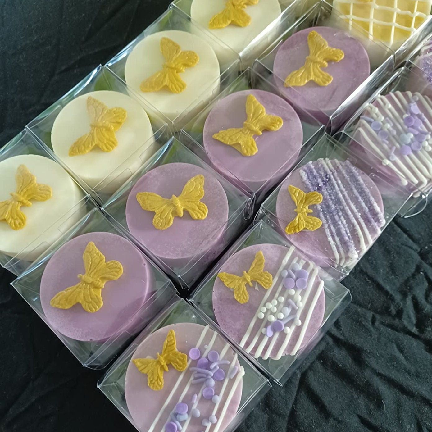 Purple and yellow butterfly-top desserts boxed in single clear PET cubes