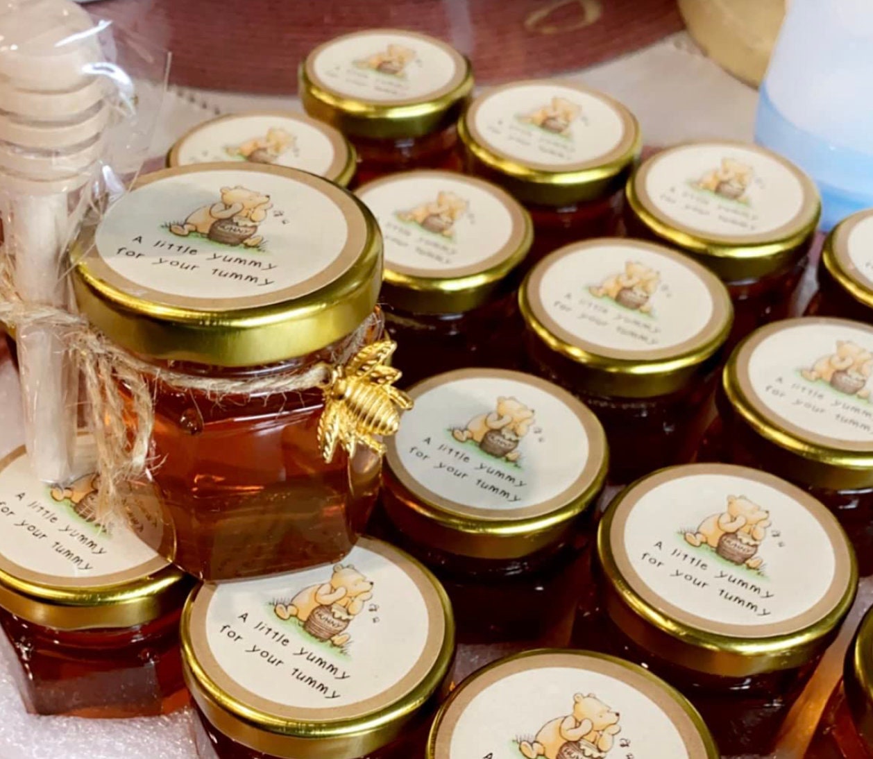 Mini honey jars with custom labels, ideal for baby shower favors.  