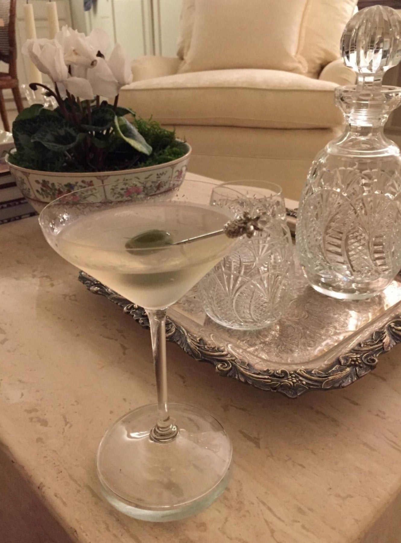 Elegant martini setup with pineapple stirrer on silver tray