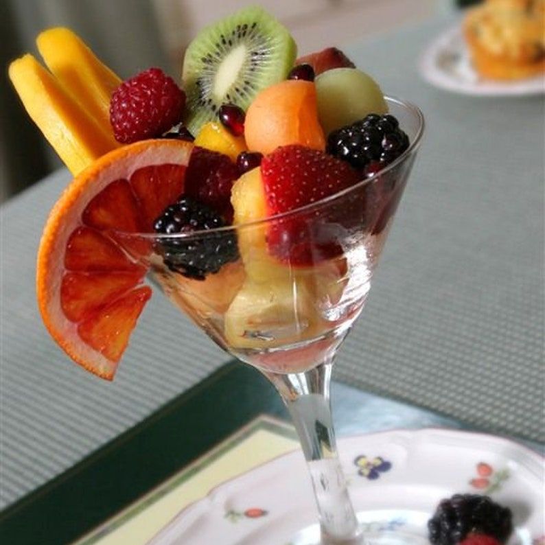 Clear acrylic martini cup with fresh fruit salad and mini fork